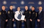 Police Chief and Officers accepting accreditation certificate